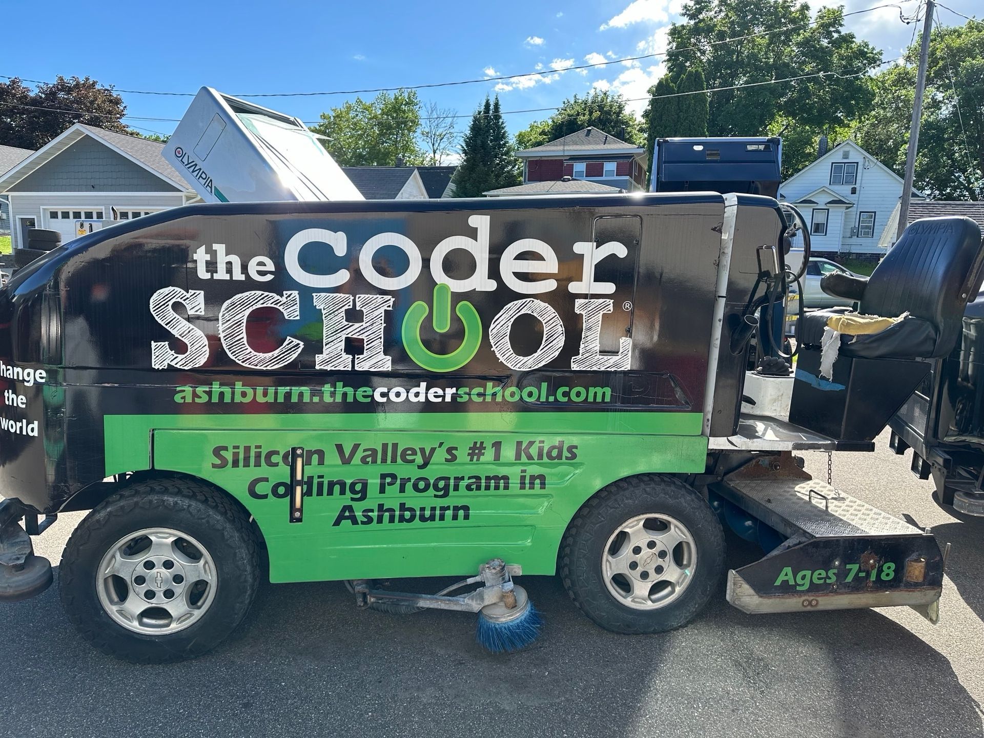 A black and green vehicle with the coder school written on it
