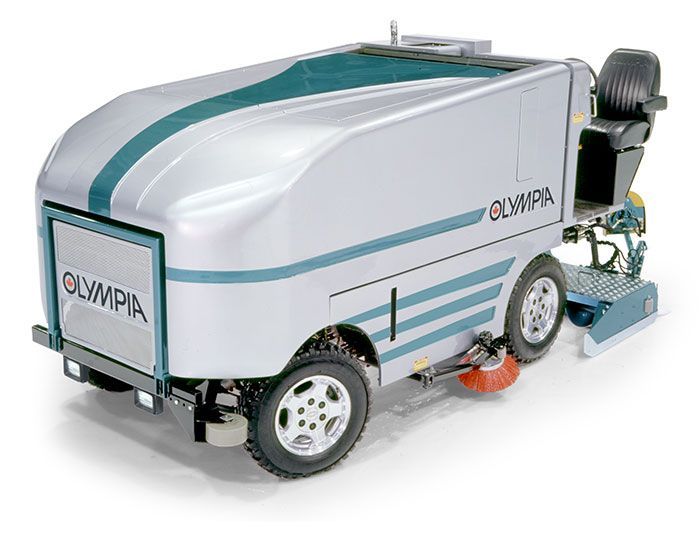 A silver and green olympia ice hockey machine is sitting on a white surface.