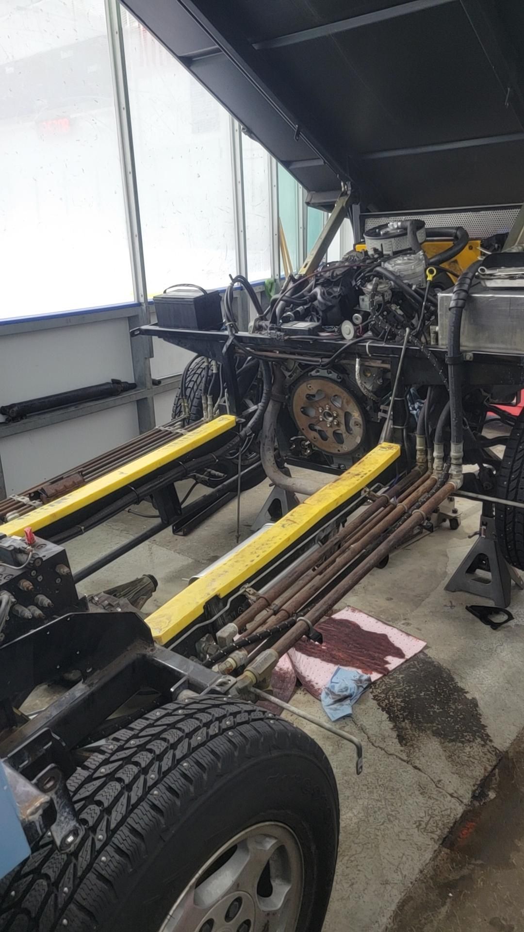 A motorcycle is being worked on in a garage.