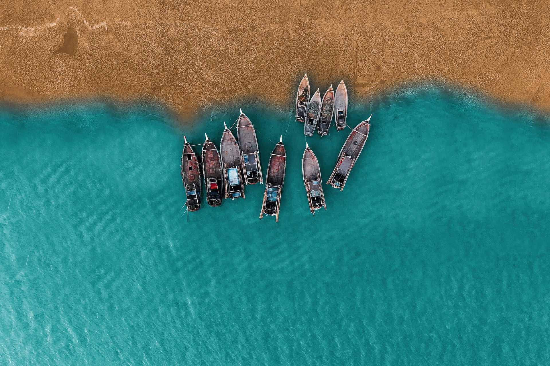 A group of boats are floating on top of a body of water.