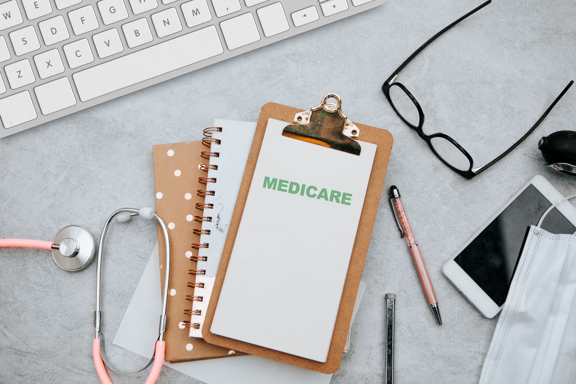 Stethoscope with Medicare form over a desk.