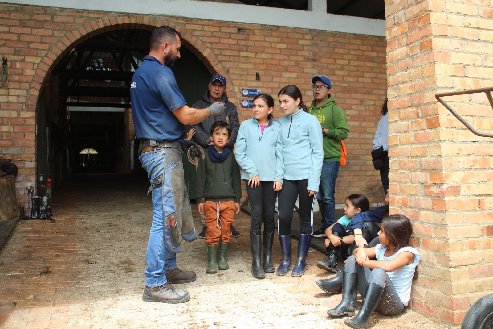 A group of people standing in front of a brick building