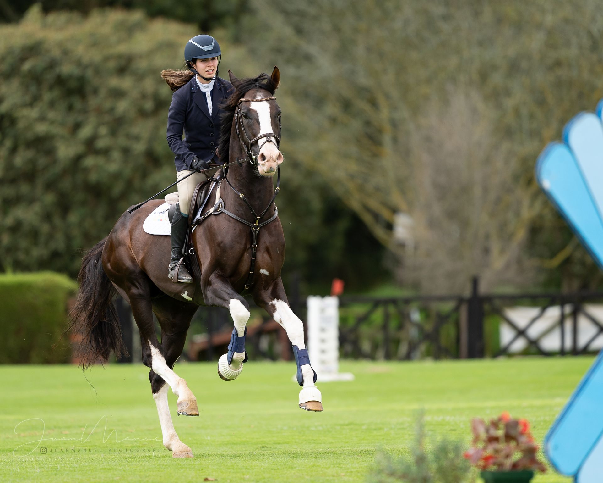 A woman is riding a horse in a field.