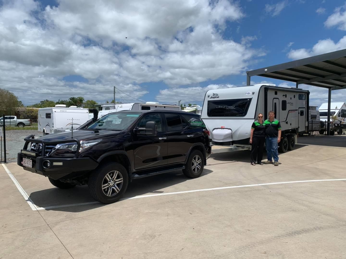Black Suv Towing a White Caravan — A.M.D. Automotive Services in Mackay, QLD