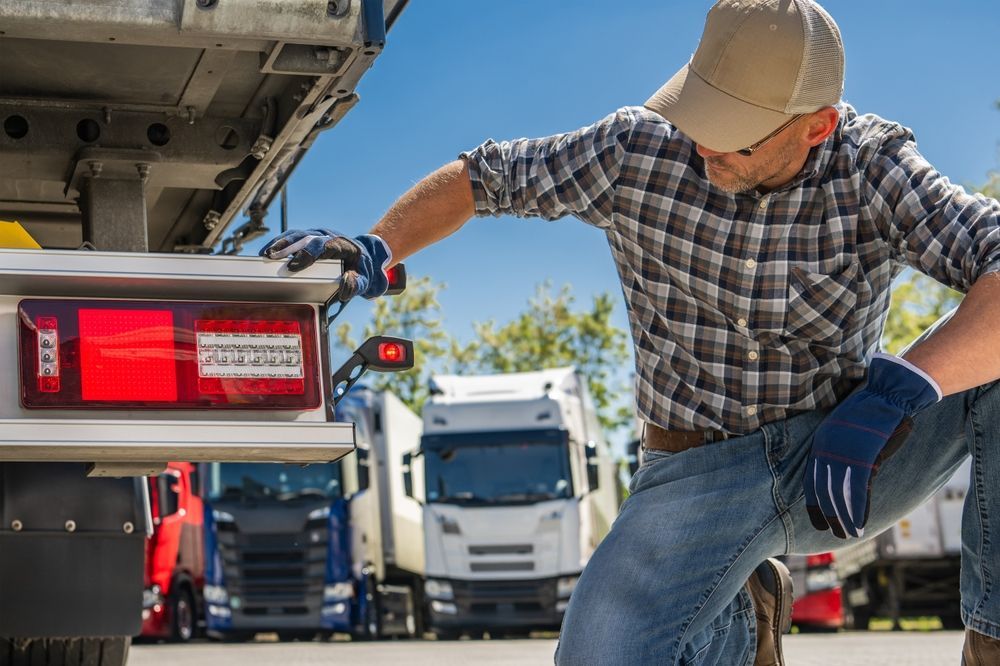Truck Driver Checks Rear Lights on Semi-trailer — A.M.D. Automotive Services in Marian, QLD