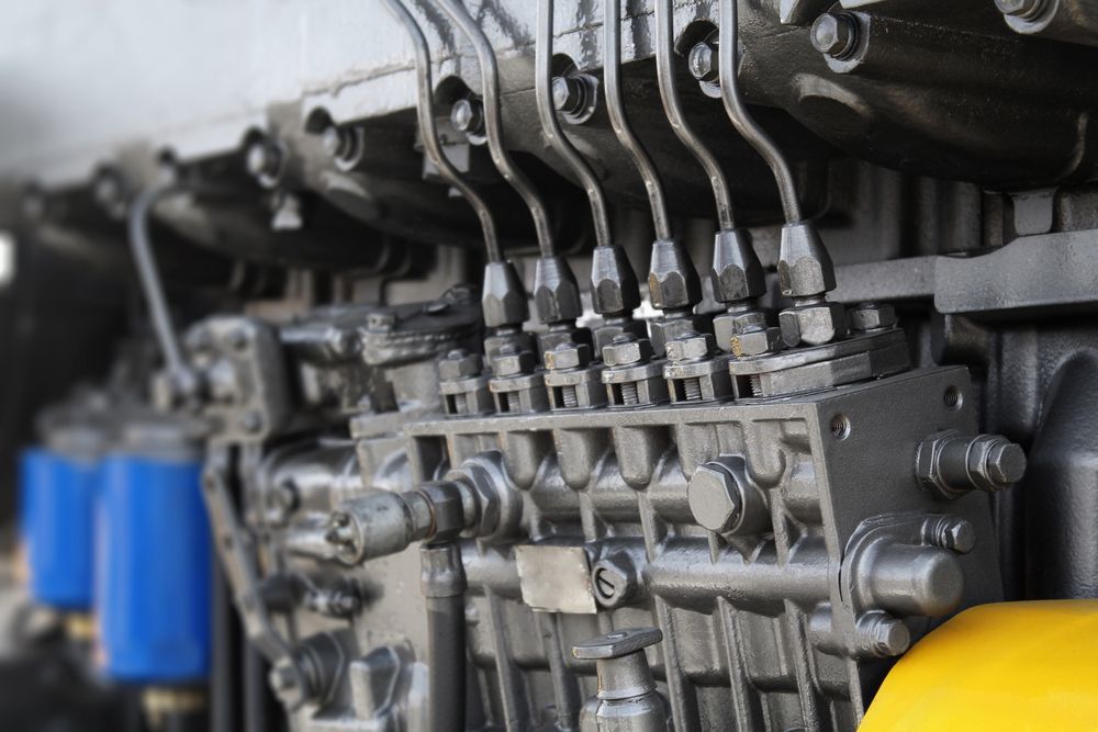 Close-up of a Dark Grey Engine With Multiple Tubes and Pipes — A.M.D. Automotive Services in Mackay, QLD