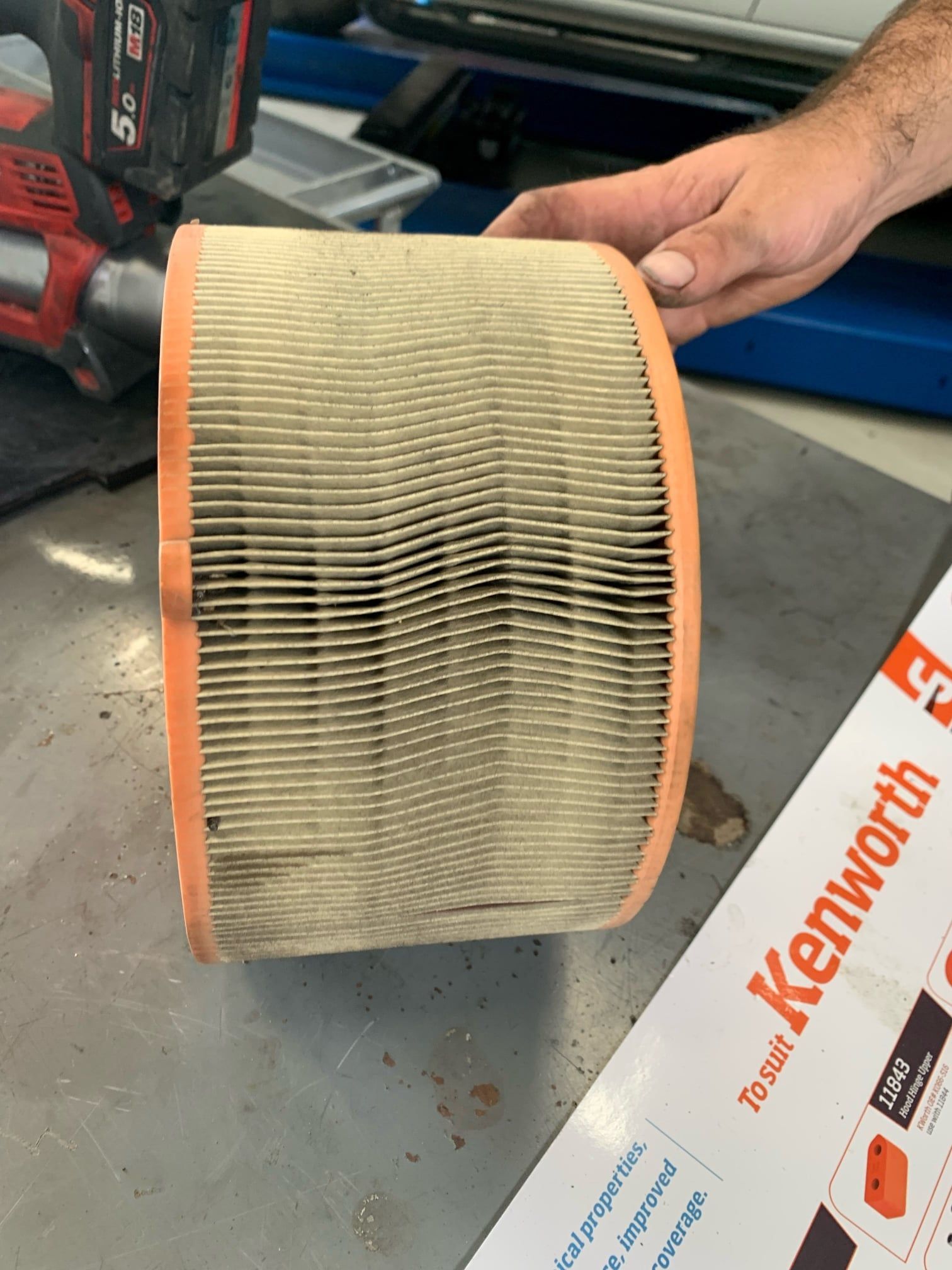 Dirty Air Filter Held by a Person — A.M.D. Automotive Services in Rural View, QLD