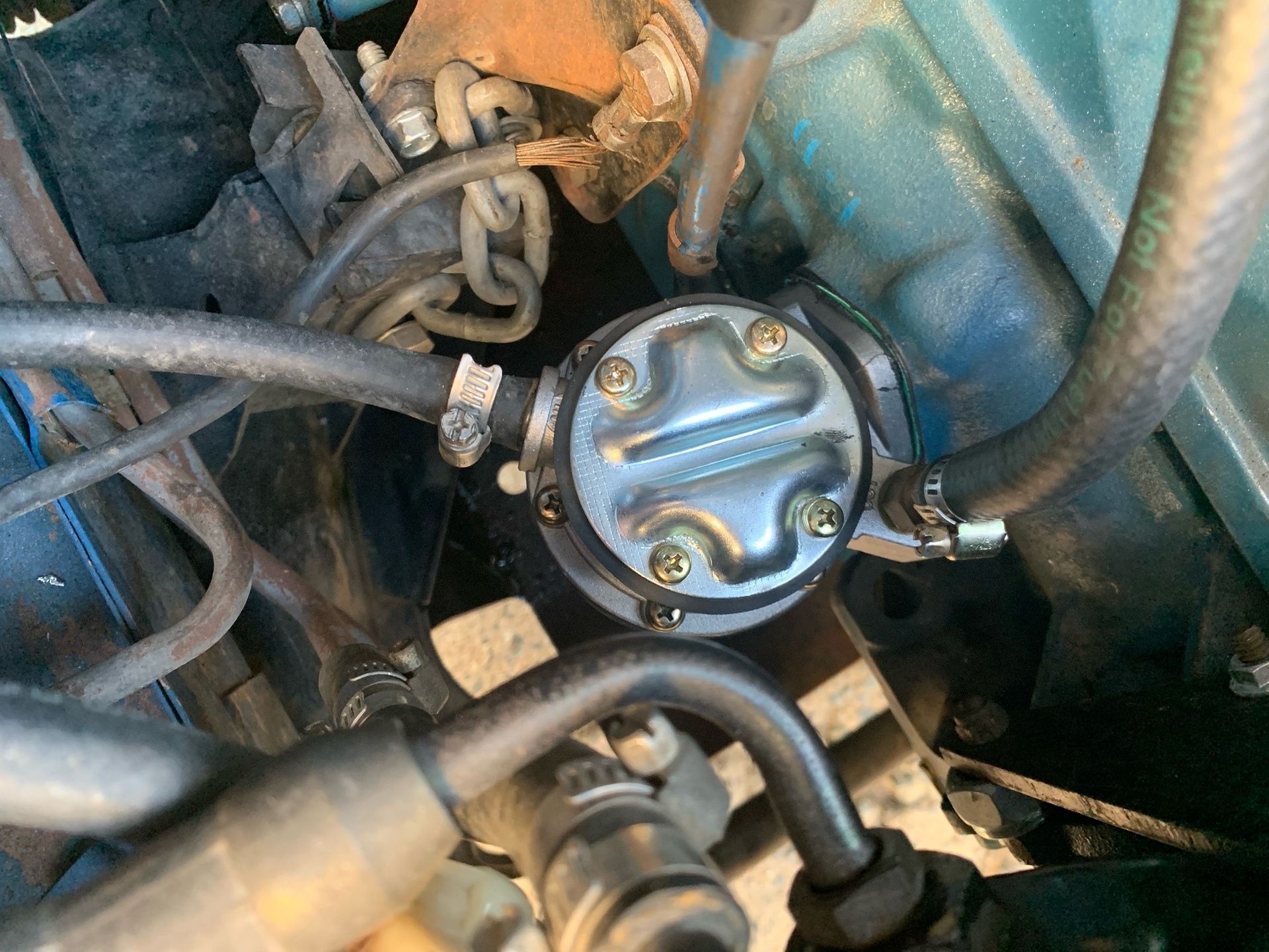 Close-up of a Silver Fuel Pump Attached to a Blue Engine Block — A.M.D. Automotive Services in Mackay, QLD