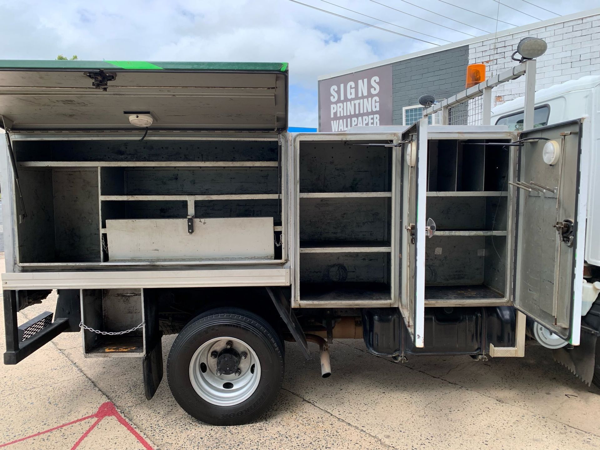 Side View of a Utility Truck With Open Compartments — A.M.D. Automotive Services in Mackay, QLD