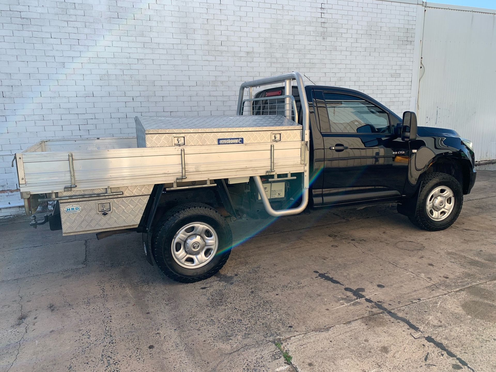 Black Pickup Truck With an Aluminum Flatbed and Toolboxes Parked — A.M.D. Automotive Services in Mackay, QLD