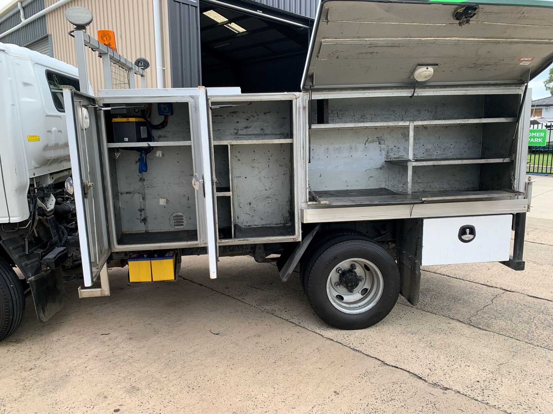 White Utility Truck With Open Compartments — A.M.D. Automotive Services in Mackay, QLD