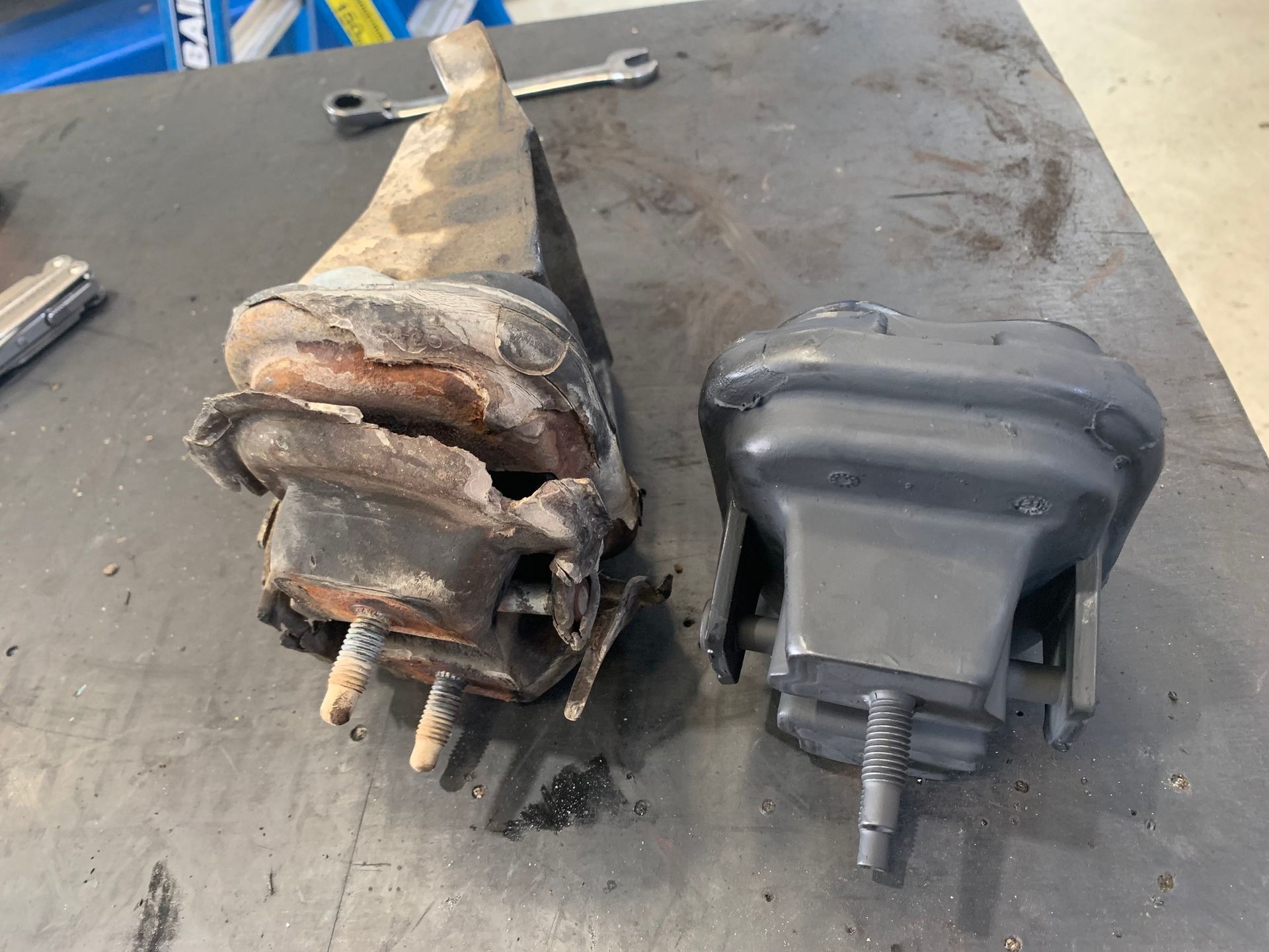 Old and New Car Engine Mounts Side by Side on a Workbench — A.M.D. Automotive Services in Proserpine, QLD