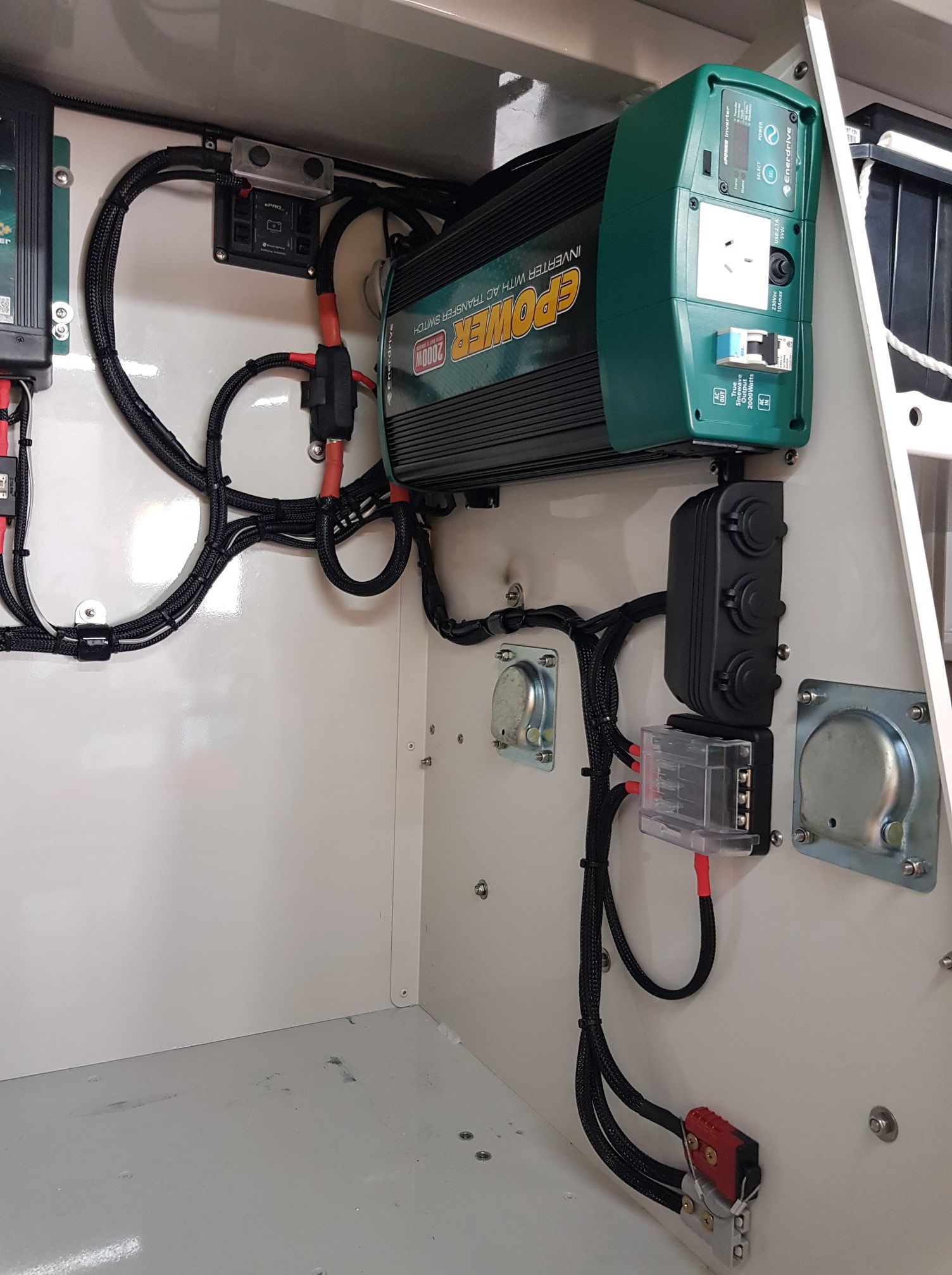 Electrical Components Mounted Inside a White Cabinet — A.M.D. Automotive Services in Mackay, QLD
