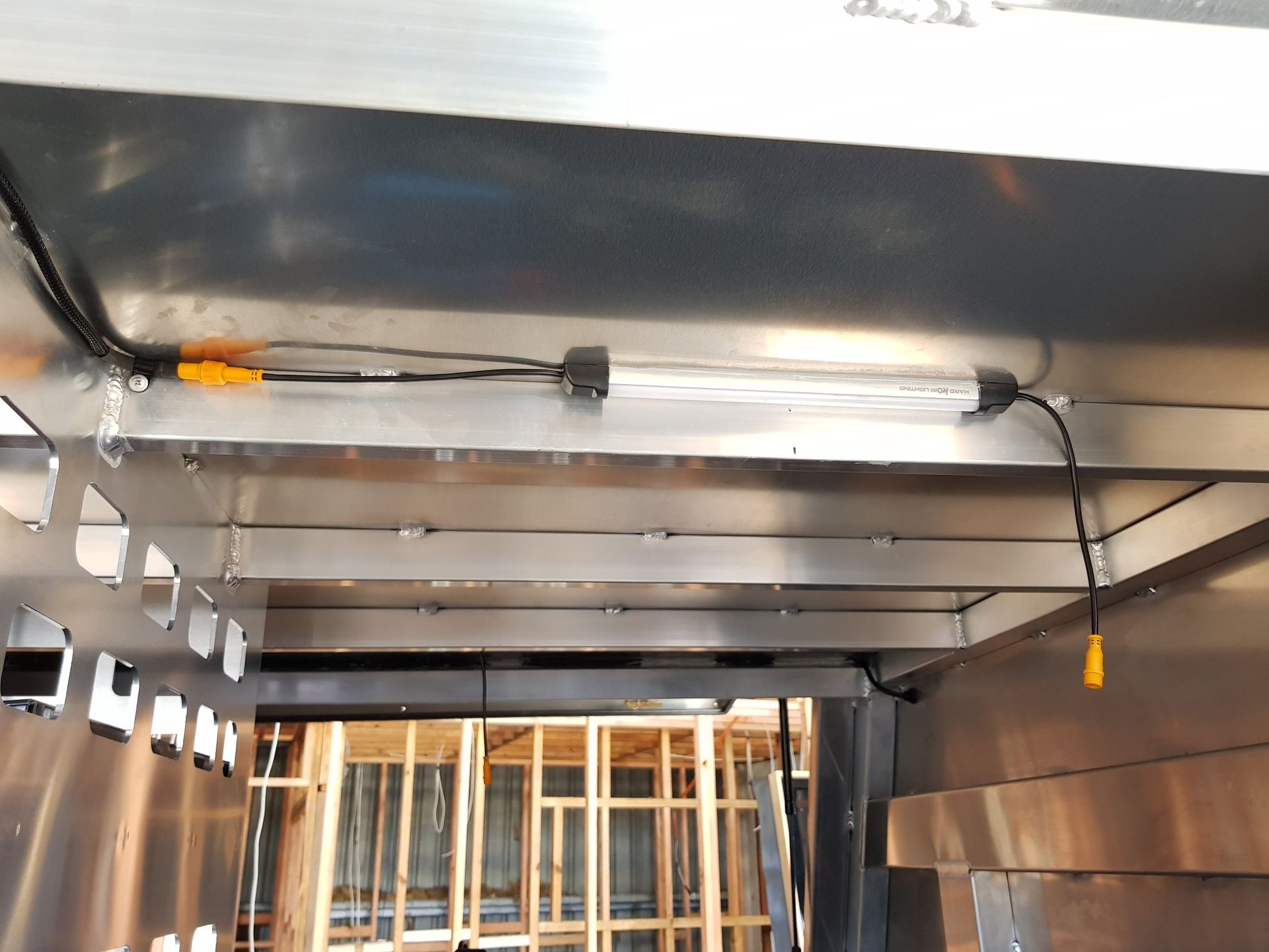 Fluorescent Light Fixture Installed Inside a Metal Structure, Wiring Visible — A.M.D. Automotive Services in Bowen, QLD