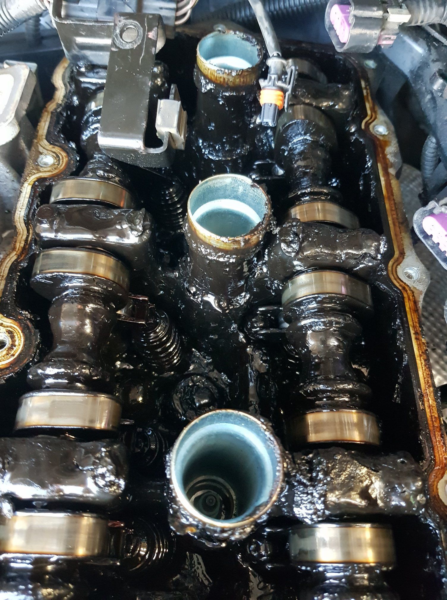 Engine Top With Visible Camshafts and Oil, Covered in Black Sludge — A.M.D. Automotive Services in Mackay, QLD