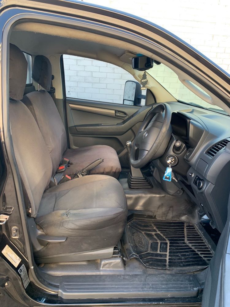 Black Truck Interior With Driver's Seat, Steering Wheel, and Floor Mats — A.M.D. Automotive Services in Mackay, QLD