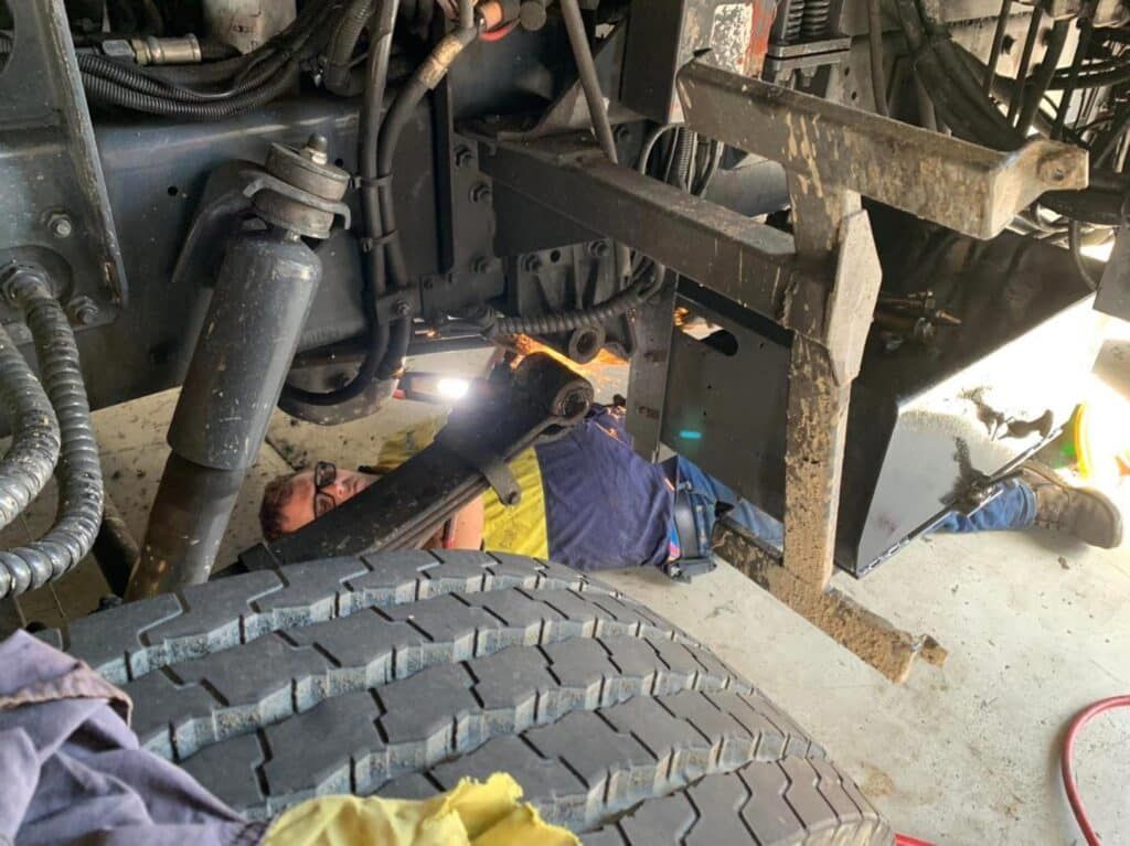 Mechanic Working Under a Truck — A.M.D. Automotive Services in Mackay, QLD