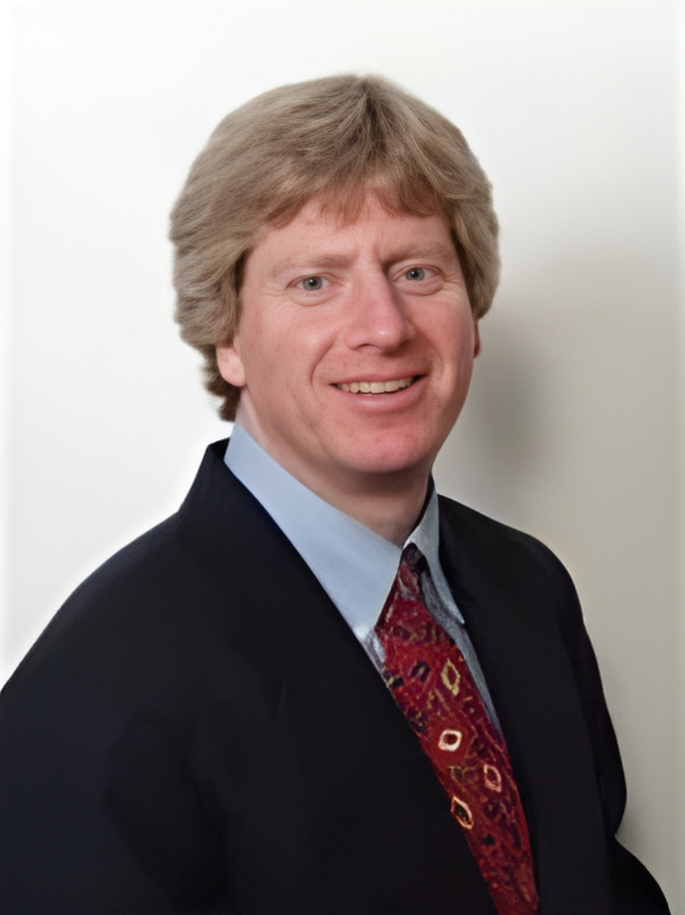 A smiling doctor in a lab coat with a stethoscope around his neck.