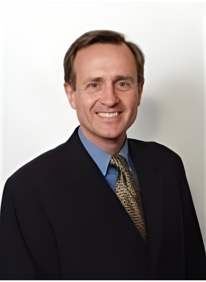 A smiling doctor in a lab coat with a stethoscope around his neck.