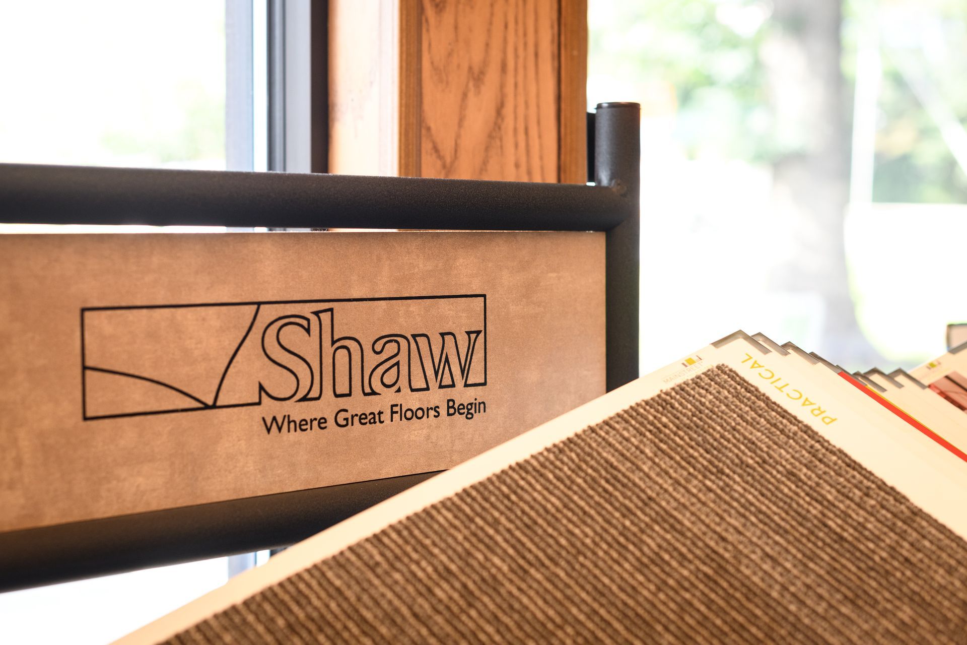 A wooden sign that says shaw where great floor begins