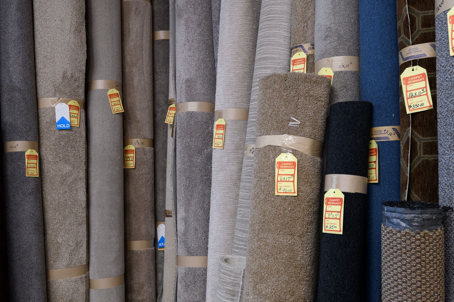 A bunch of carpets are stacked on top of each other