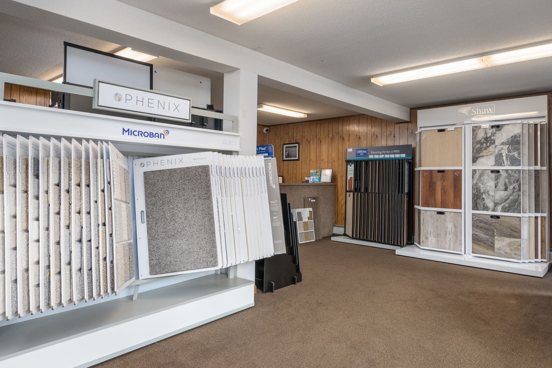 There are many different types of carpets and tiles on display in this room.