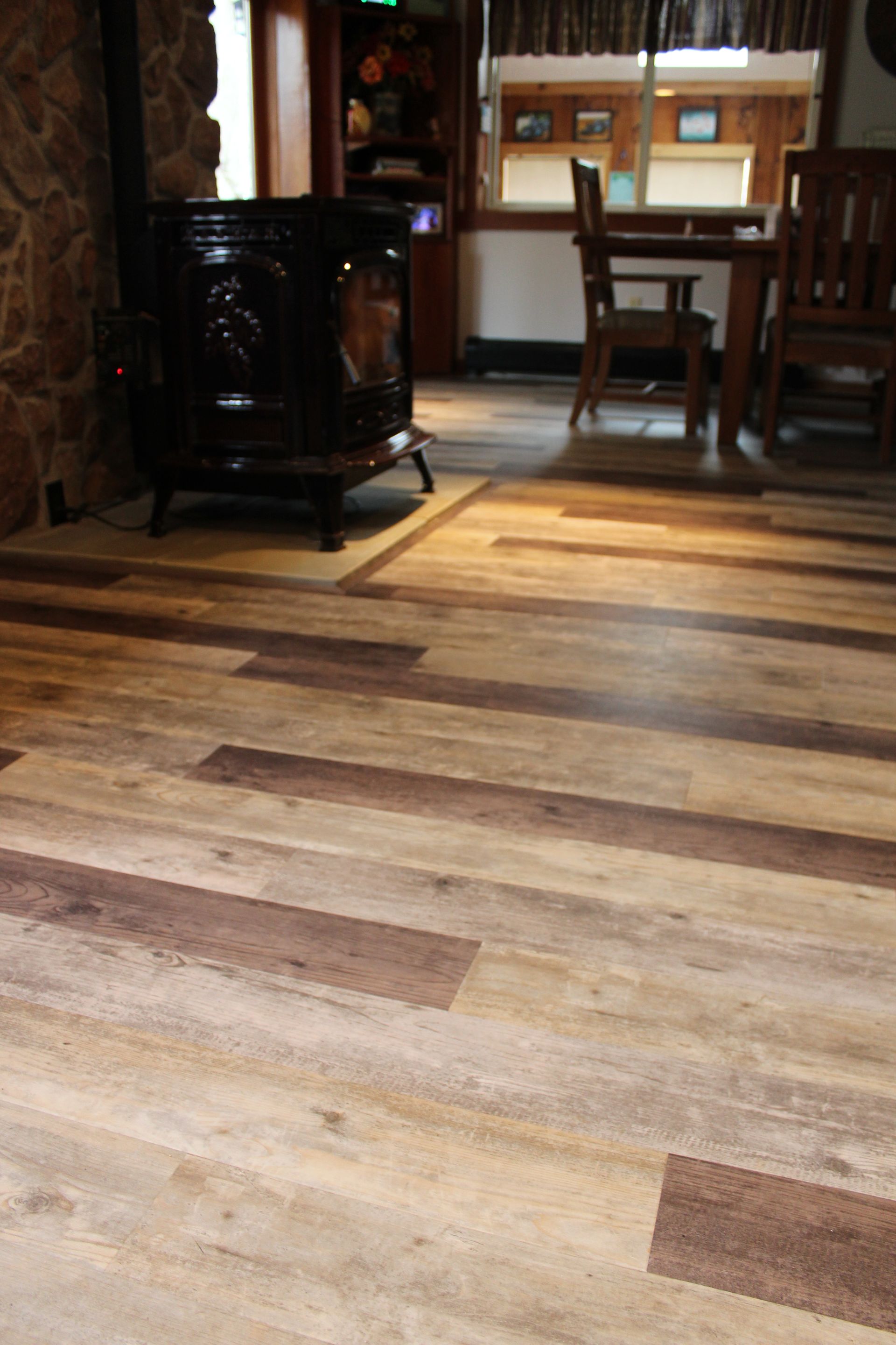 A room with wooden floors and a wood stove