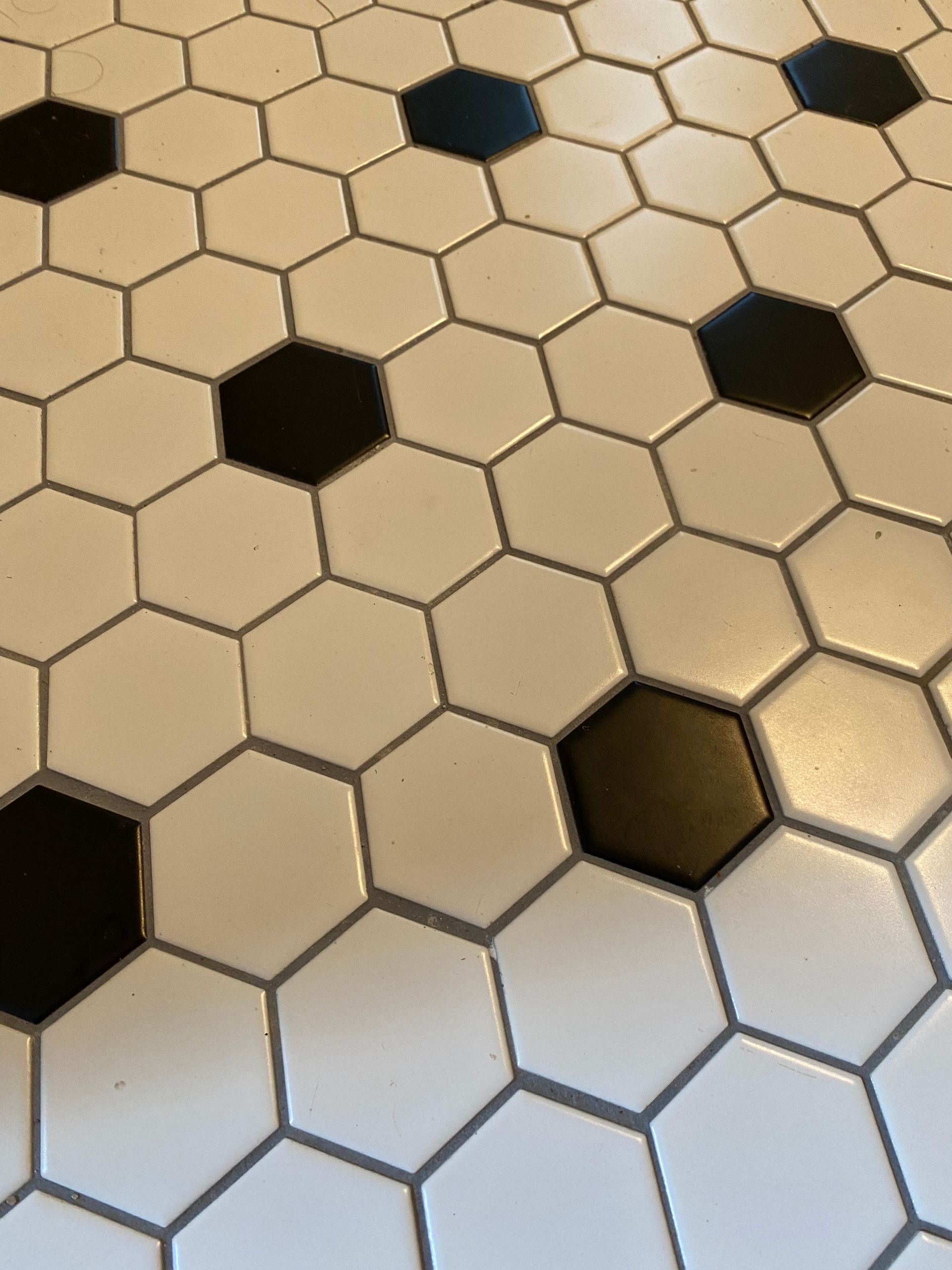 A close up of a black and white hexagon tile floor
