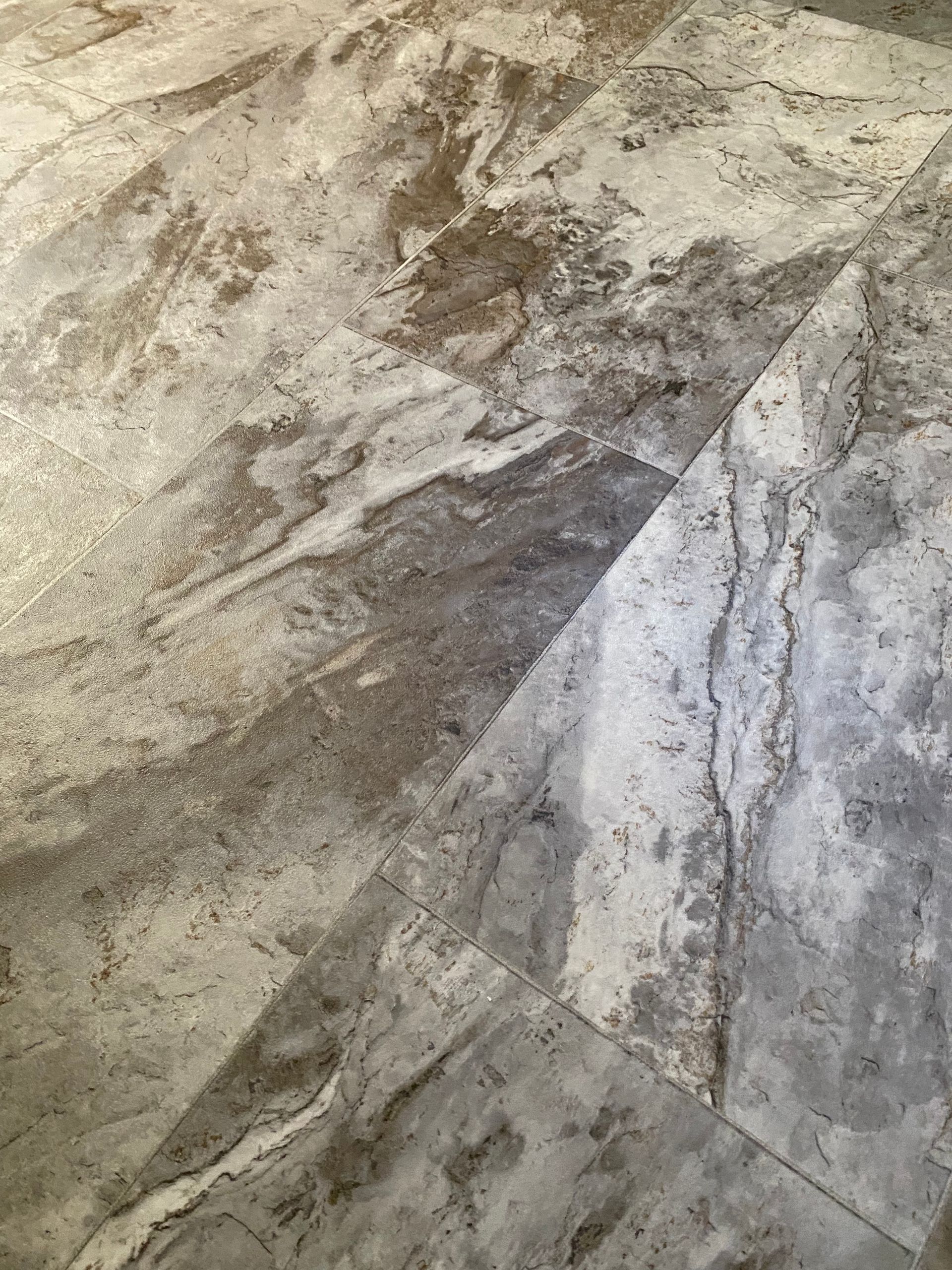 A close up of a tiled floor with a marble texture.