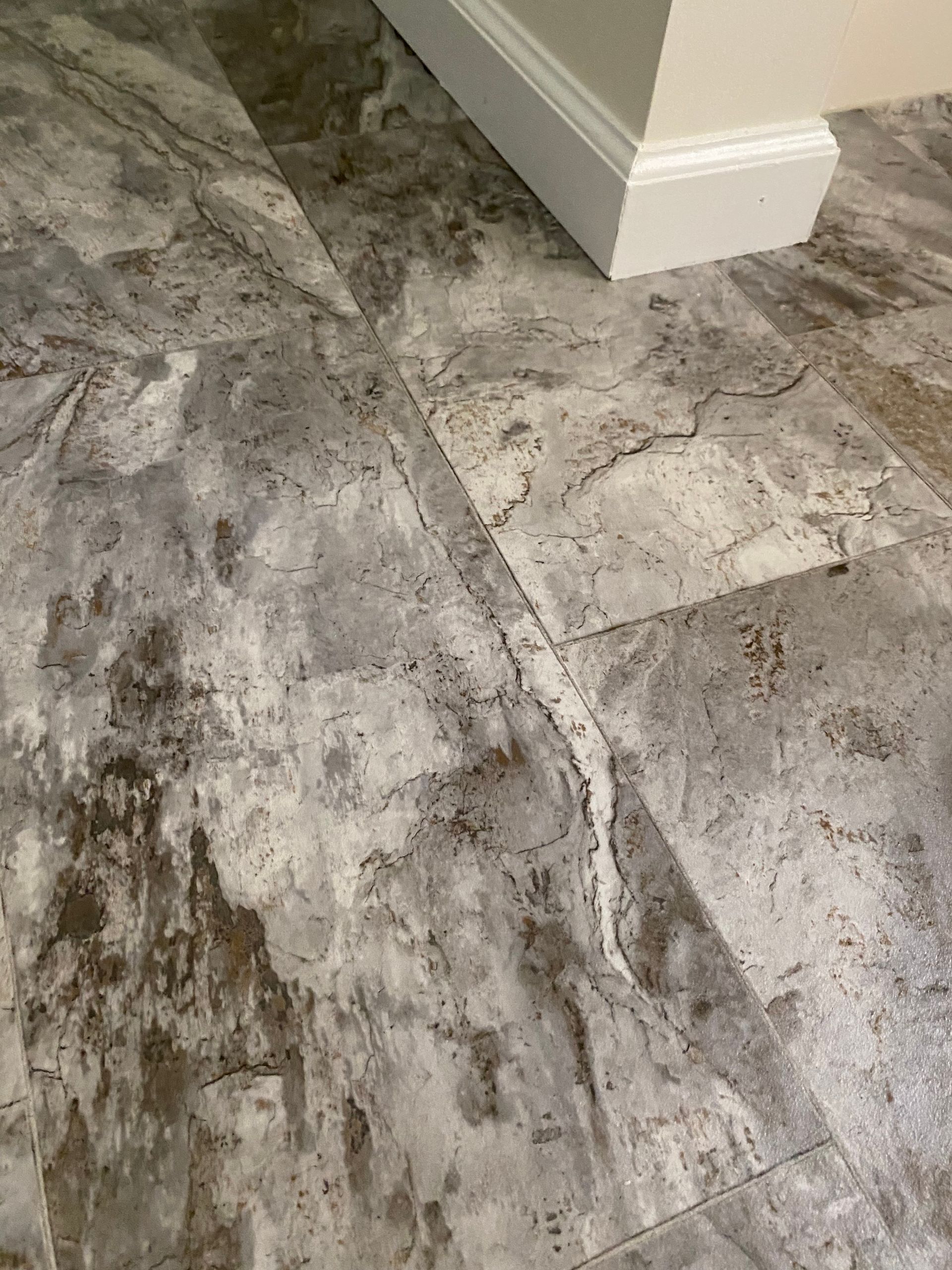 A close up of a tile floor in a room.