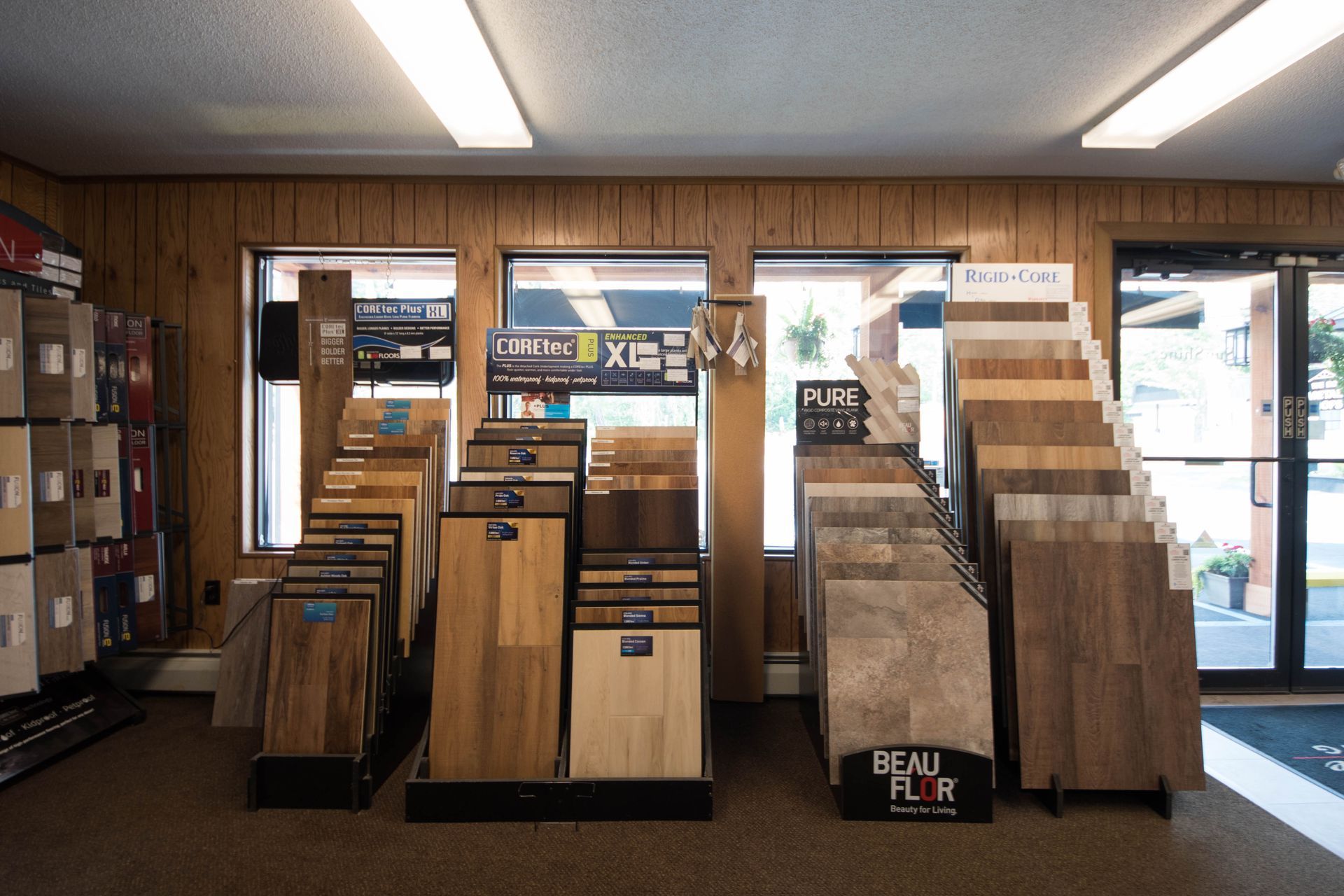 A display of wood flooring in a store with a sign that says beau floor