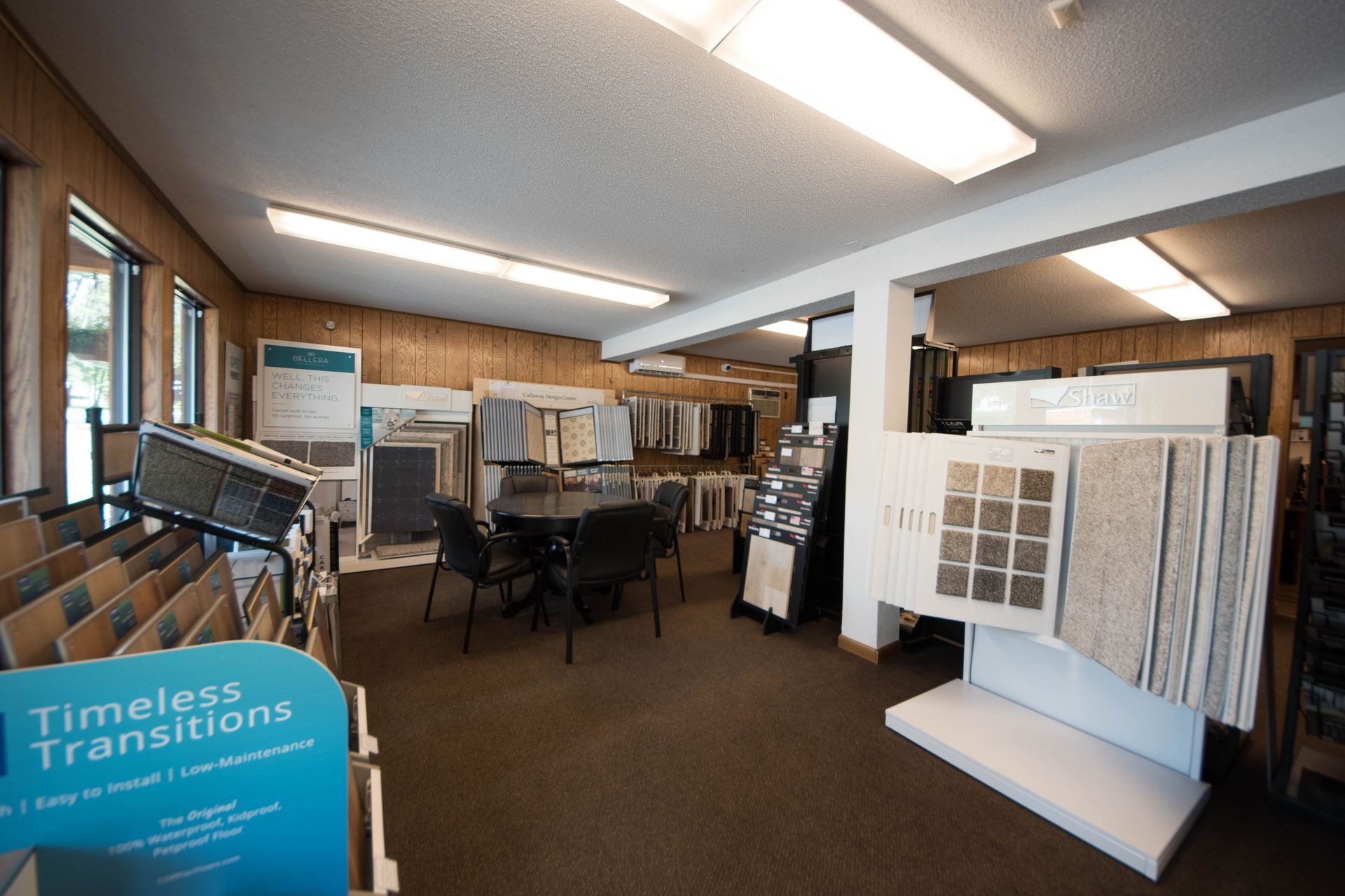 A room with a table and chairs and a sign that says timeless transitions.