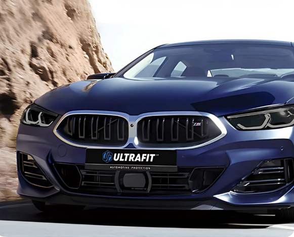 A close-up view of the rear taillight and body panel of a modern white car.