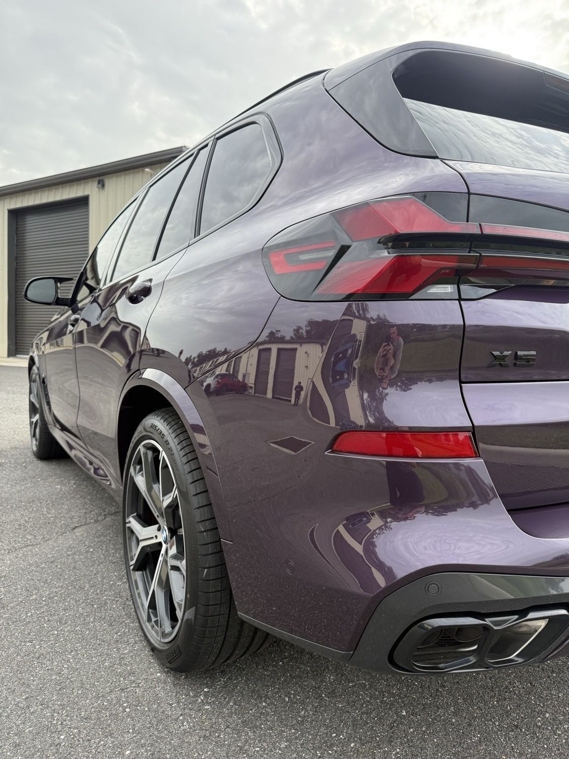 Rear quarter panel of a purple 2026 BMW X5 with full body PPF, ceramic coating and ceramic window tint