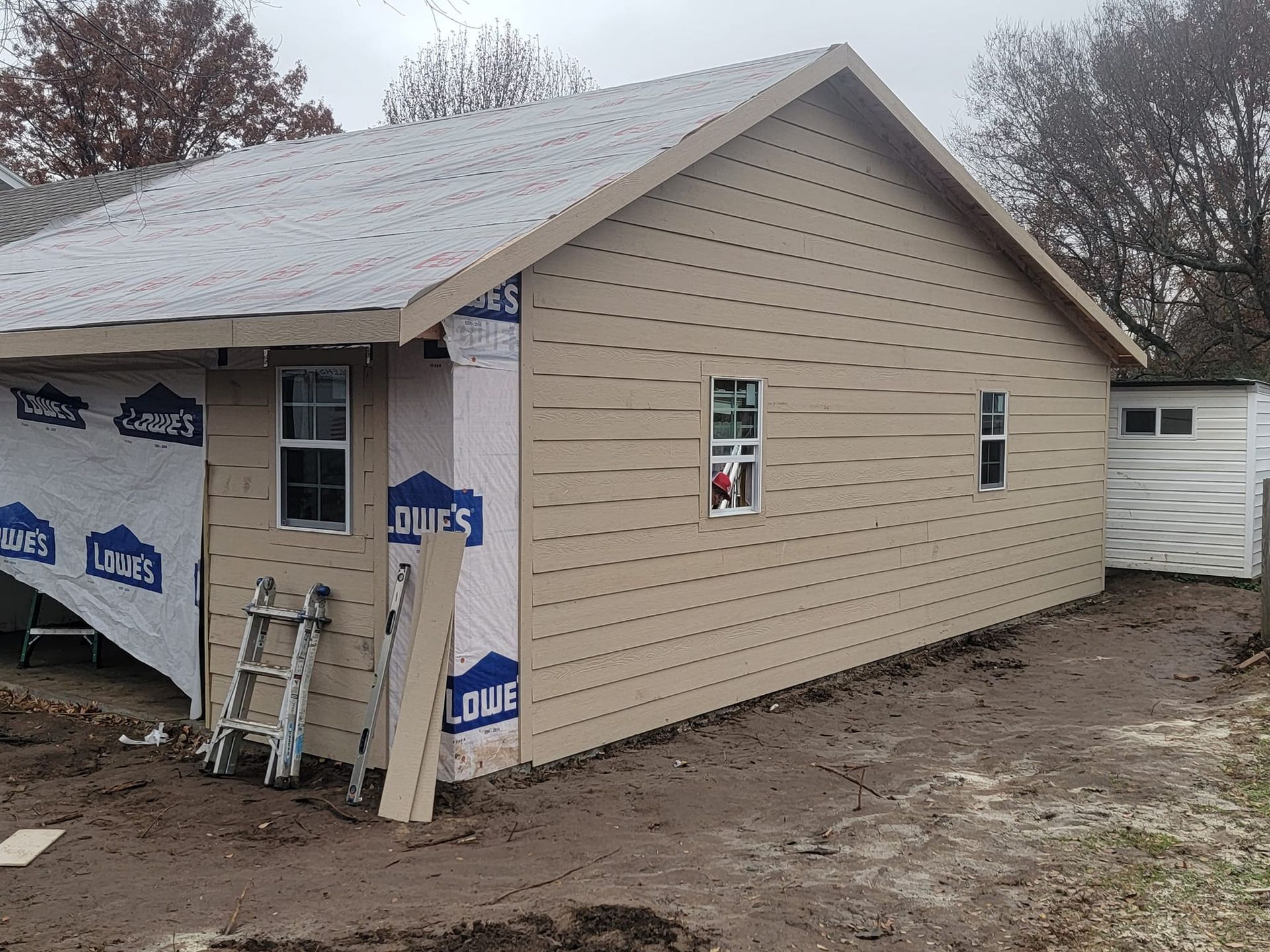 A house that is being built with a ladder in front of it
