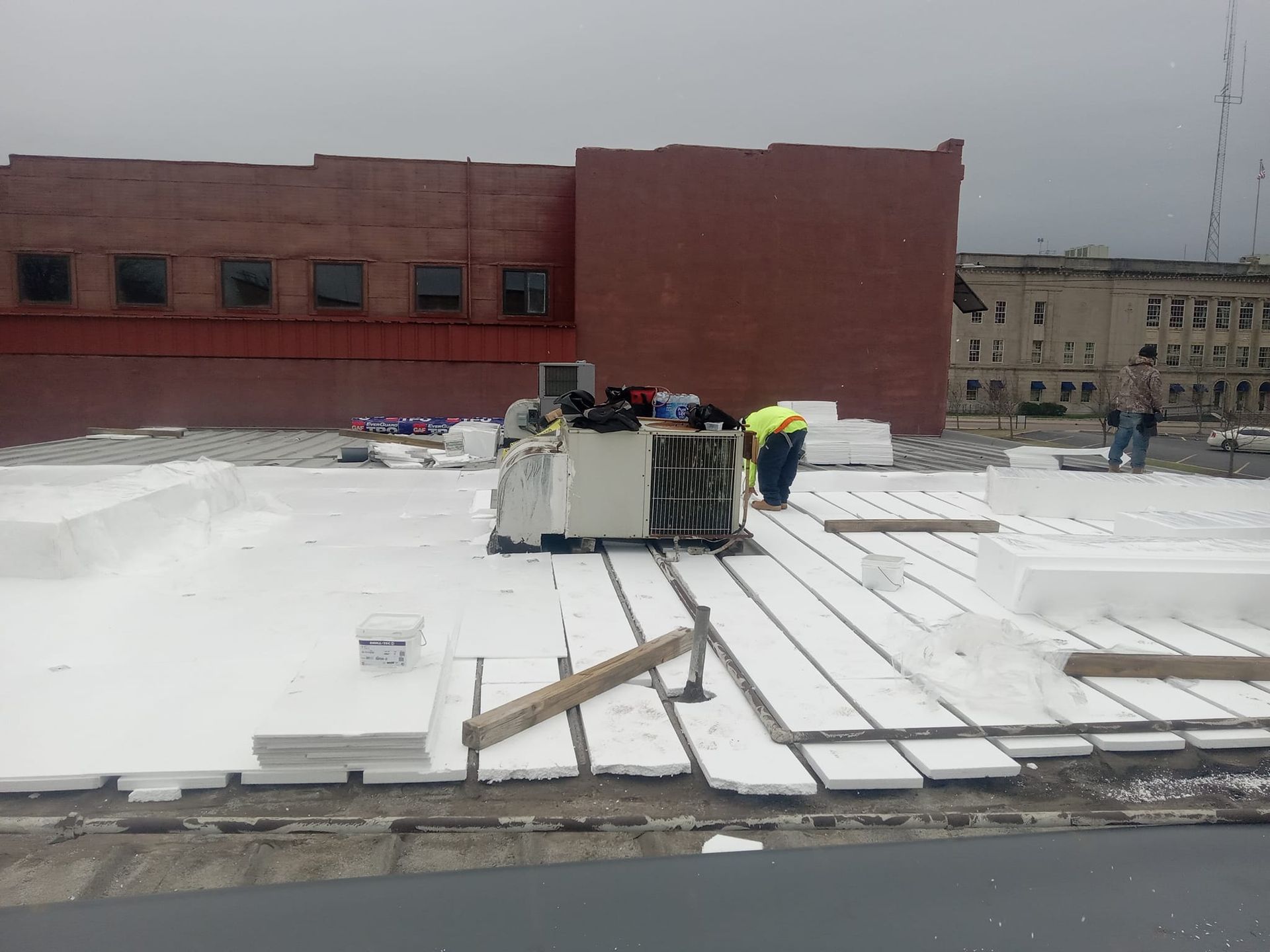 A group of people are working on a roof of a building.