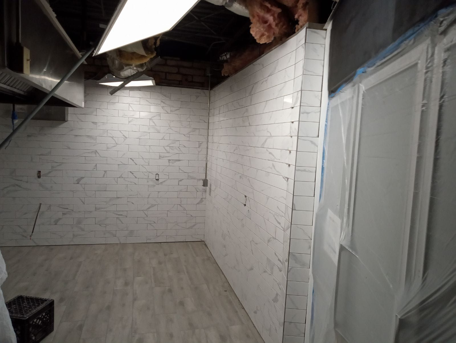 A room with white brick walls and a wooden floor
