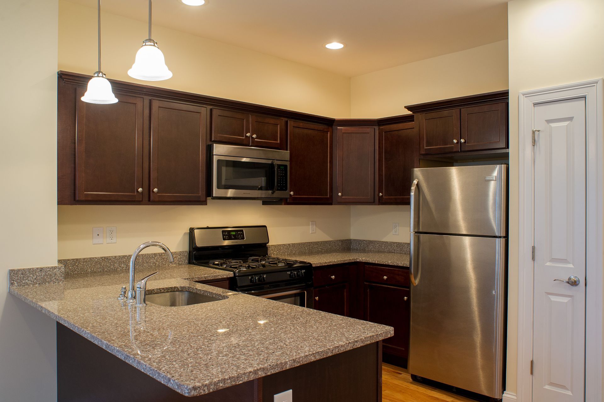 A kitchen with stainless steel appliances and granite counter tops