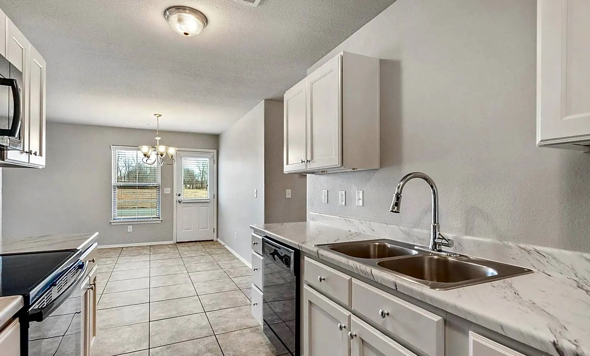kitchen alternate angle showing living room in backrgound