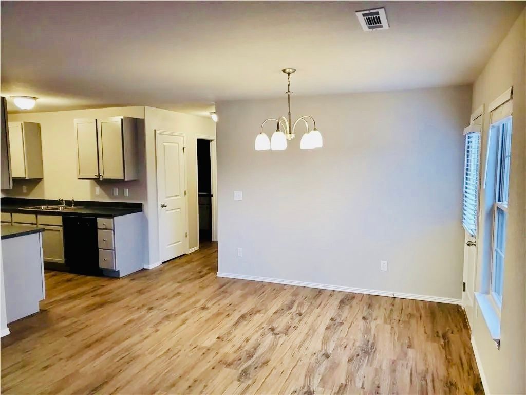 living room photo with the kitchen in background