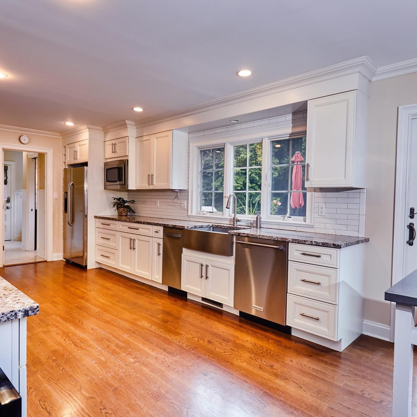 A kitchen with stainless steel appliances and white cabinets