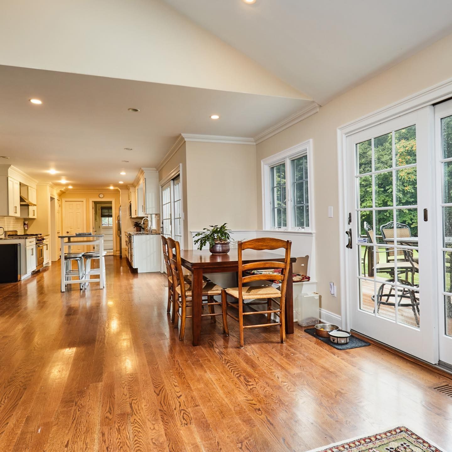 A dining room with a table and chairs and french doors