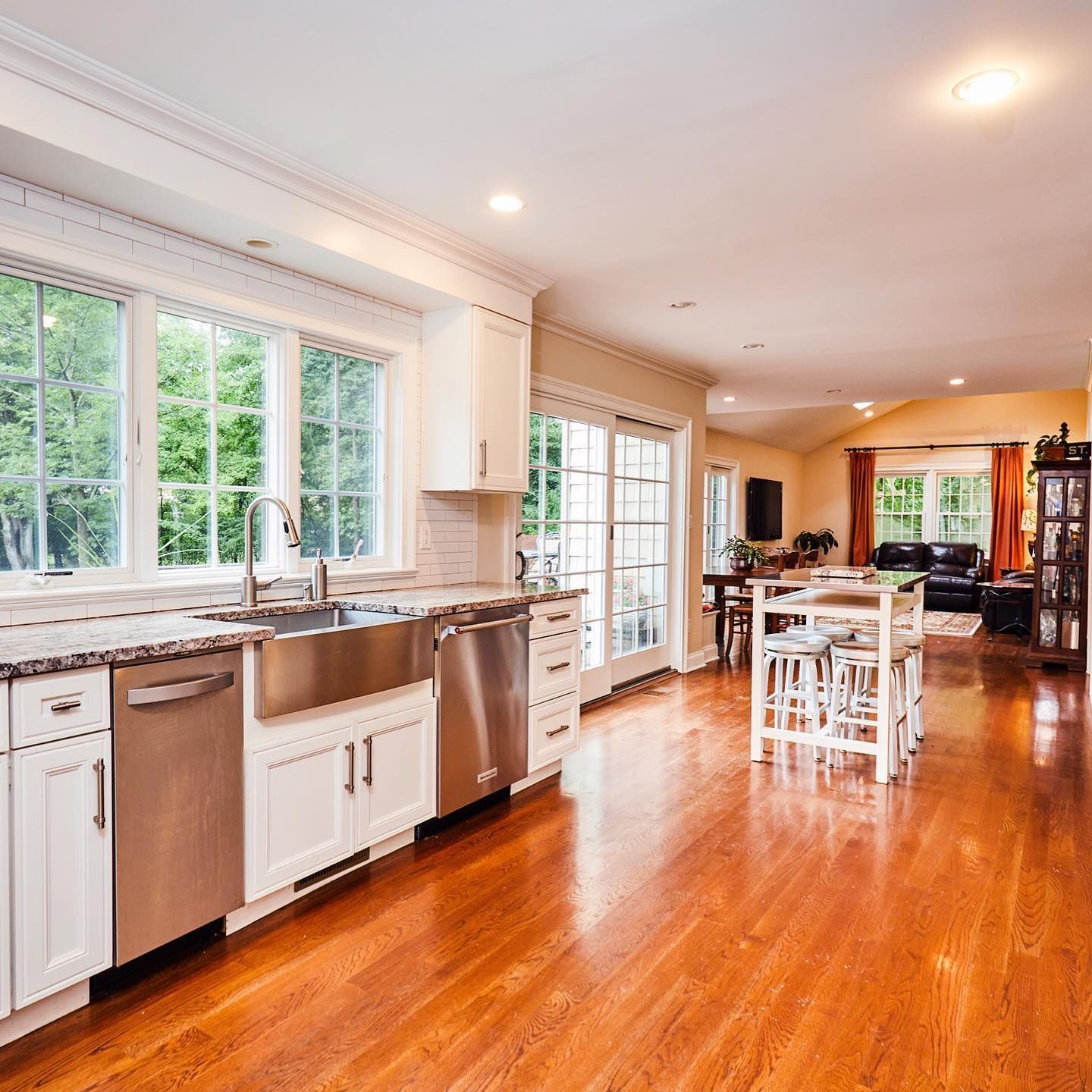A kitchen with stainless steel appliances and white cabinets