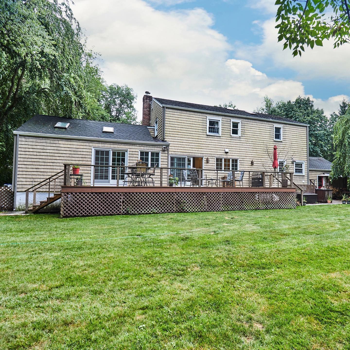 A large house with a large deck in the backyard