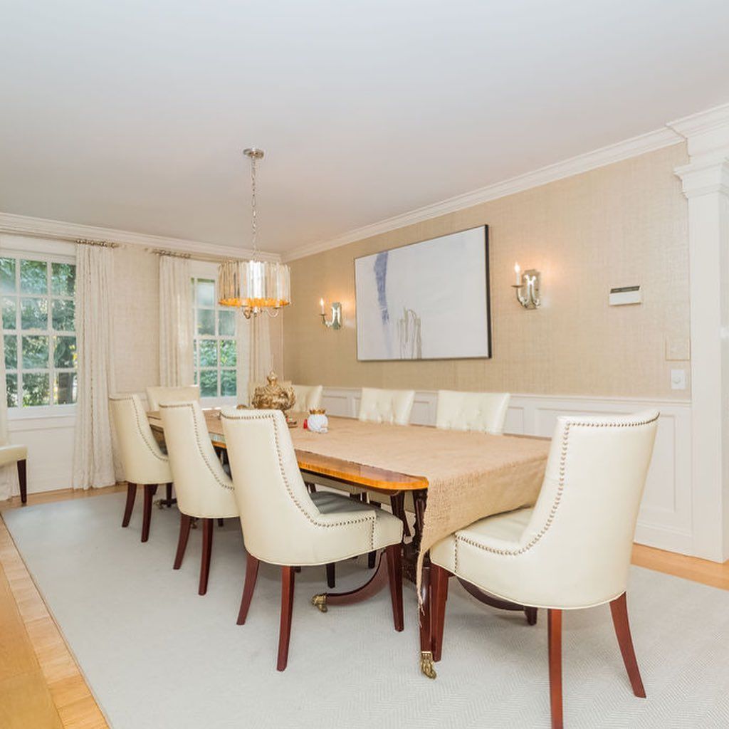 A dining room with a long table and chairs