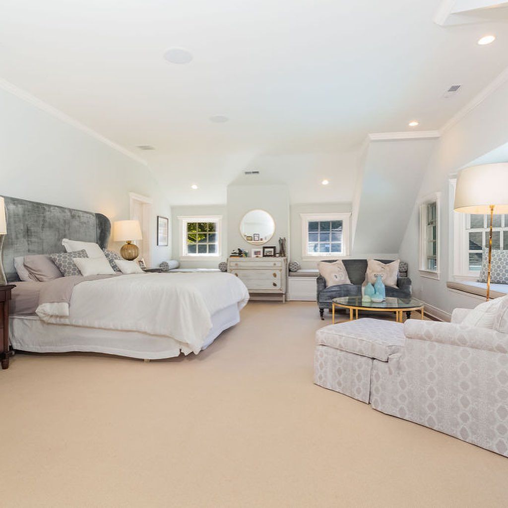 A bedroom with a large bed and a couch