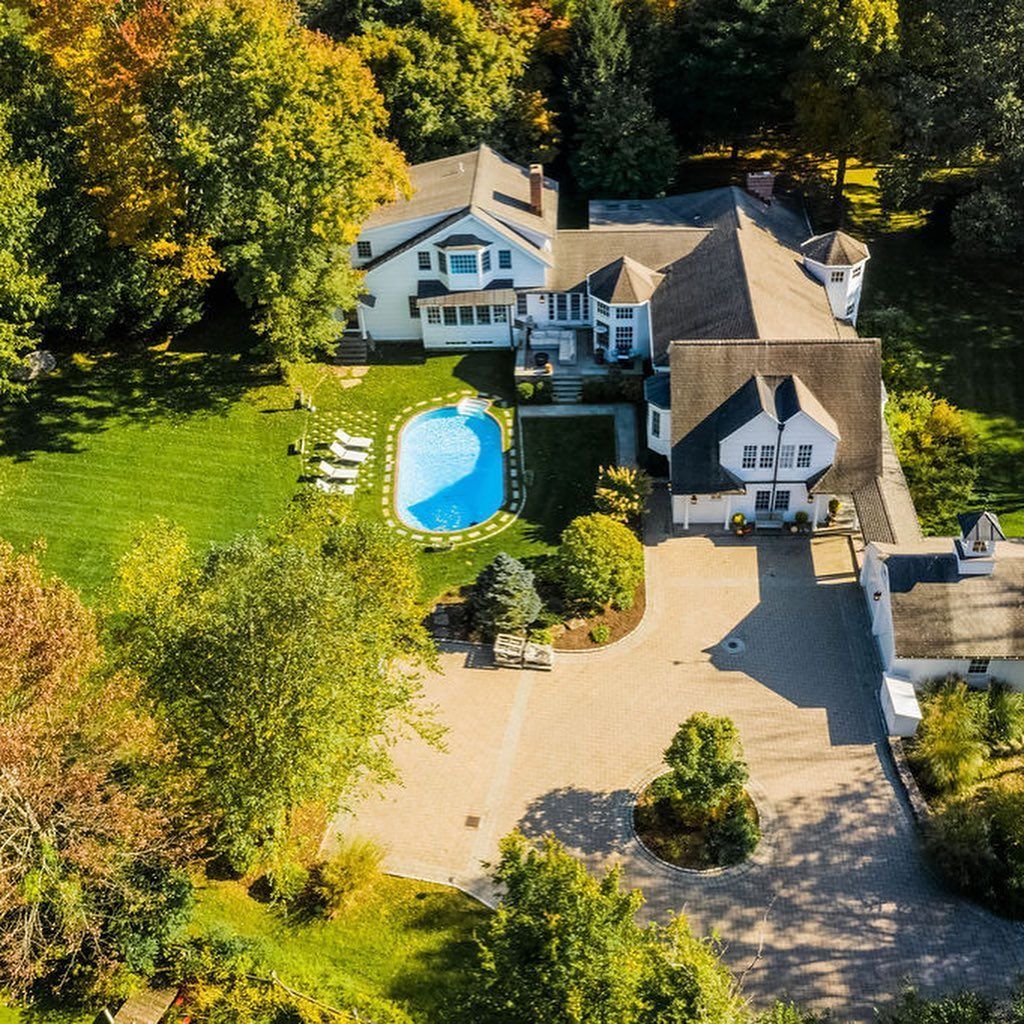 An aerial view of a large house with a pool