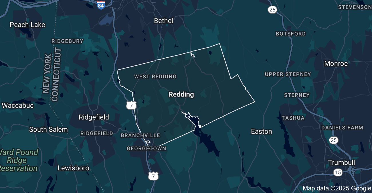 Two people are sitting at a table looking at a floor plan.