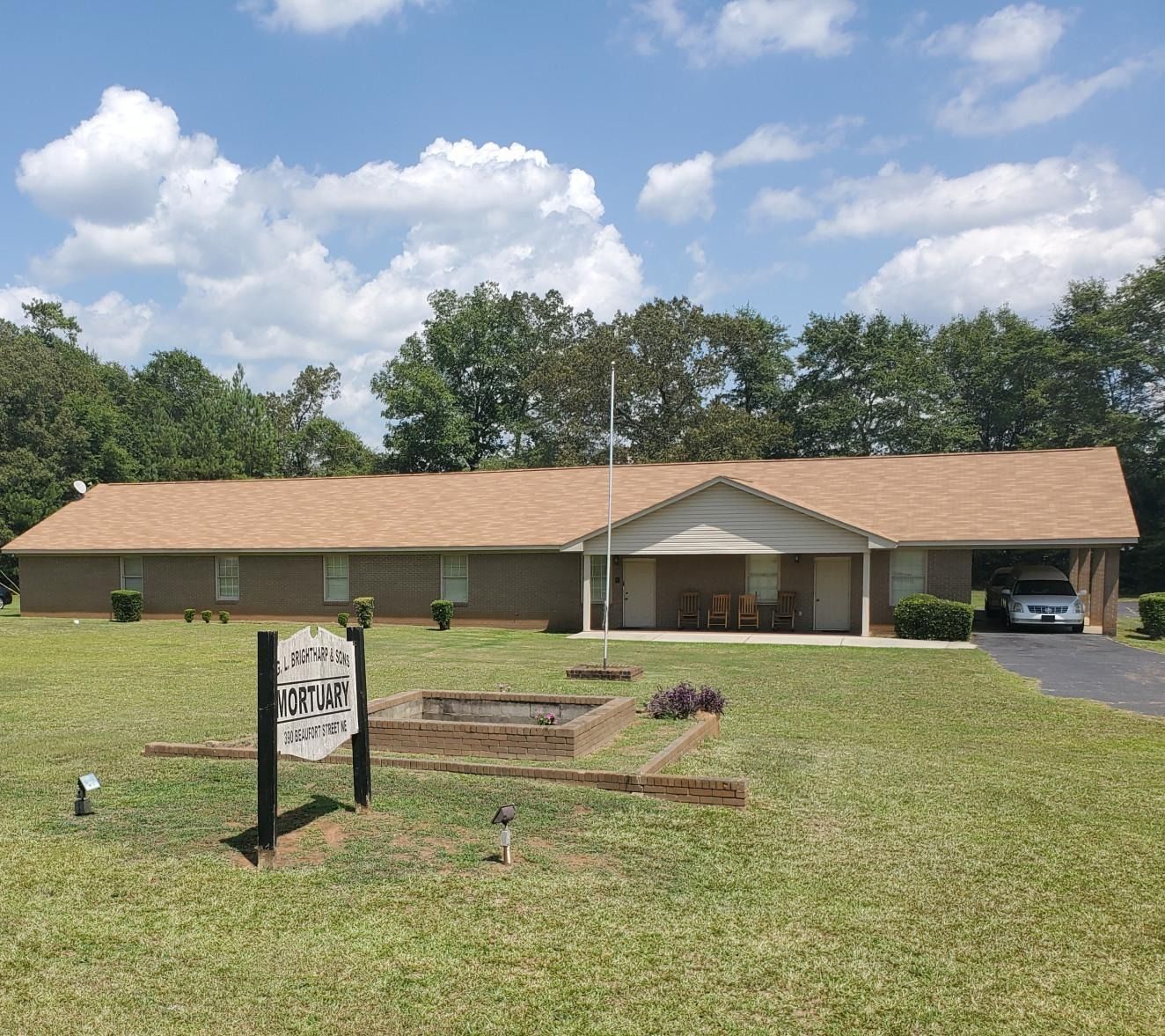 A black and white photo of a black leather couch.