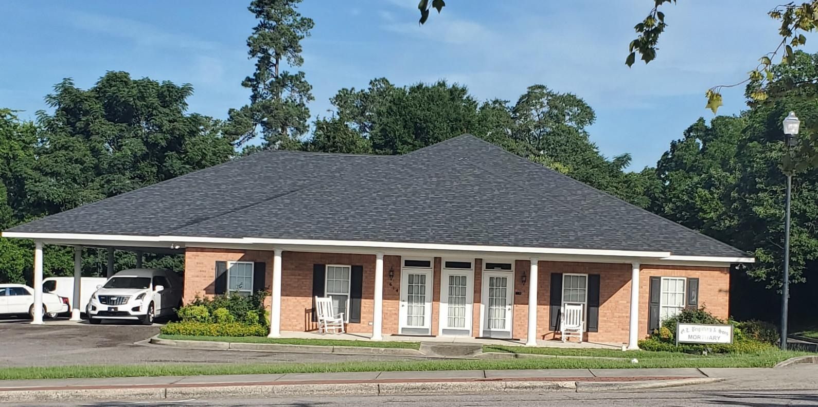 A large office building with a lot of windows on a sunny day.